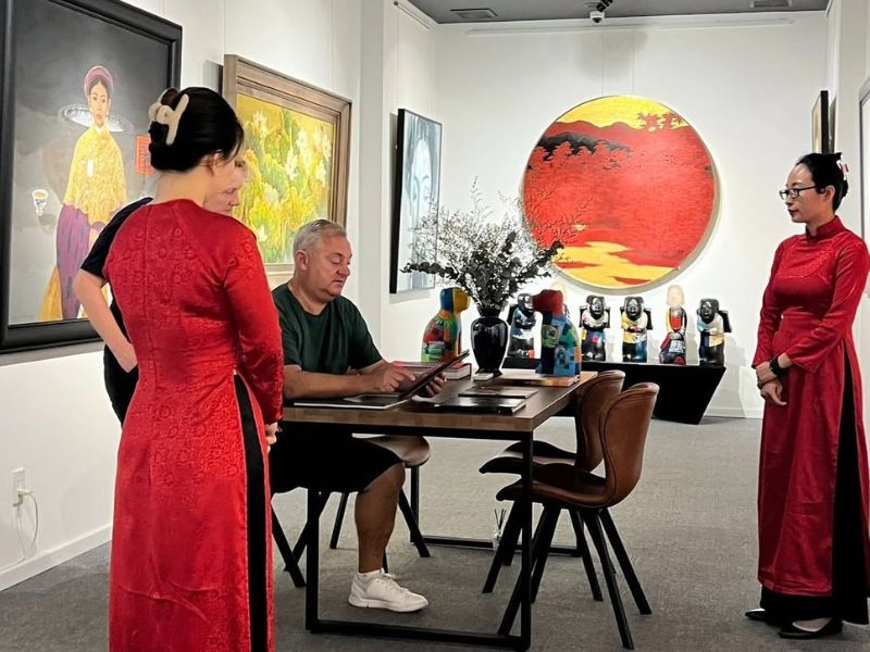 Khách hàng tham khảo tác phẩm trực tiếp trước khi lựa chọn tranh tại Green Palm Gallery.