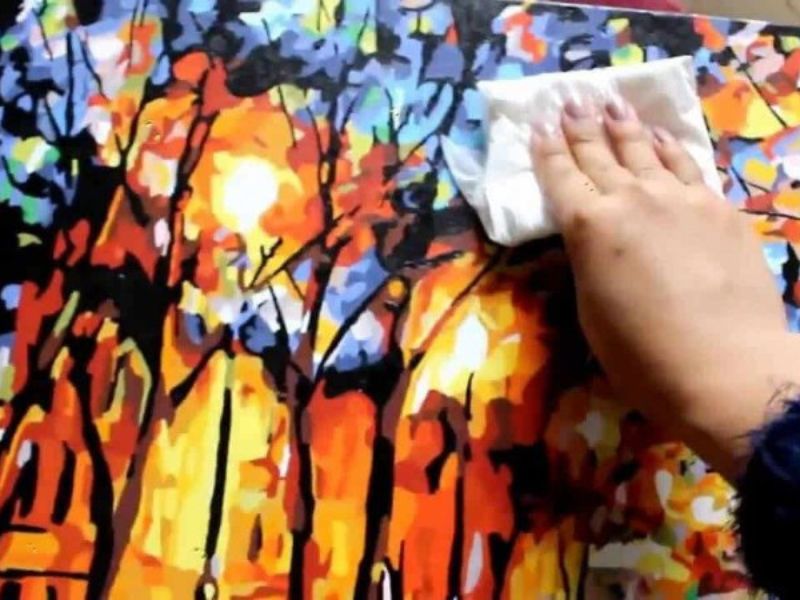 Using a dry microfiber cloth helps gently remove surface dust while keeping the artwork dry.